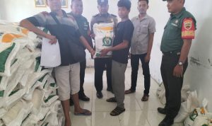 Bhabinkamtibmas Polsek Dolok, Aiptu Monang Siregar, saat mengawal jalannya penyaluran bantuan ke masyarakat